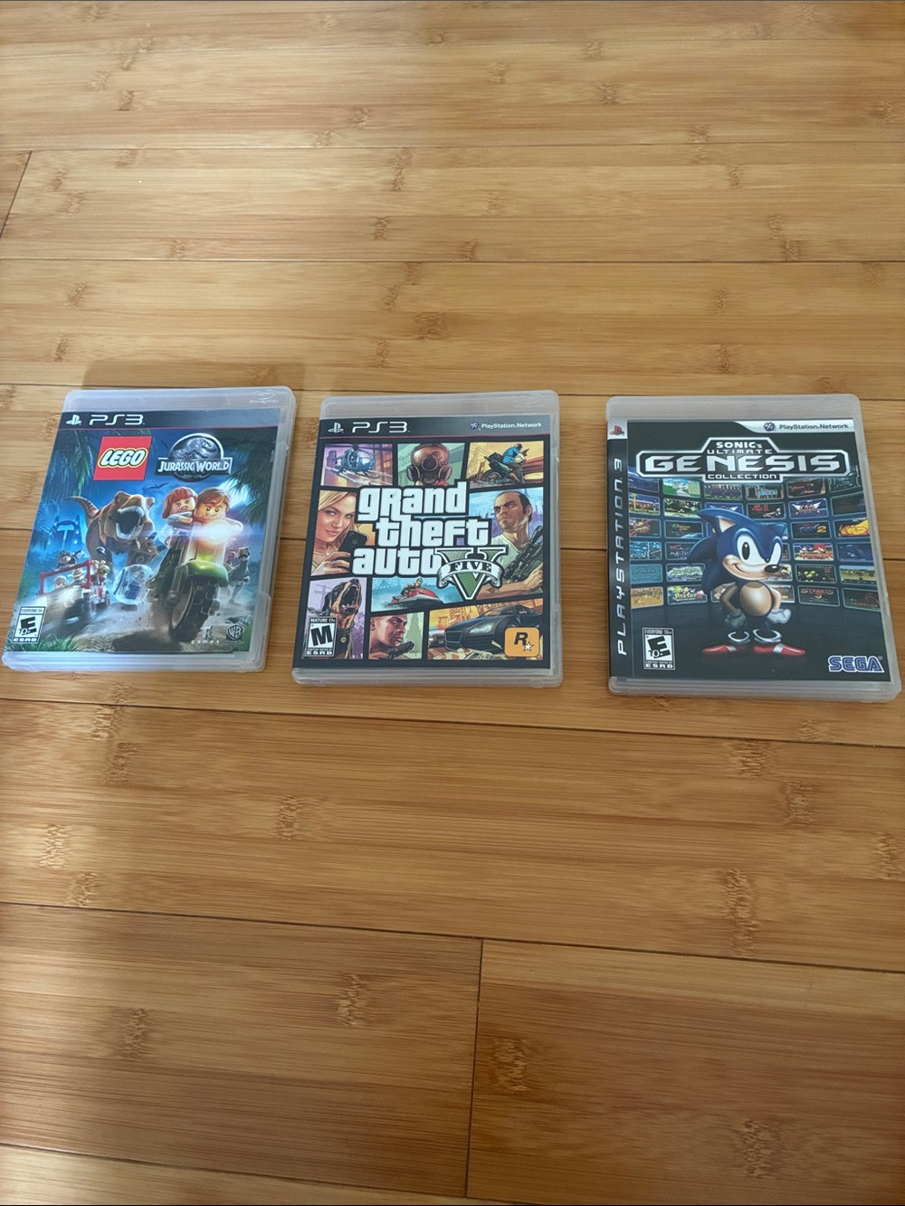 PS3 Thee Game Lot  GTA 5, Lego, Jurassic World, and sonic ultimate Genesis